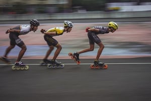 speed skating rollerbladers with blurred background